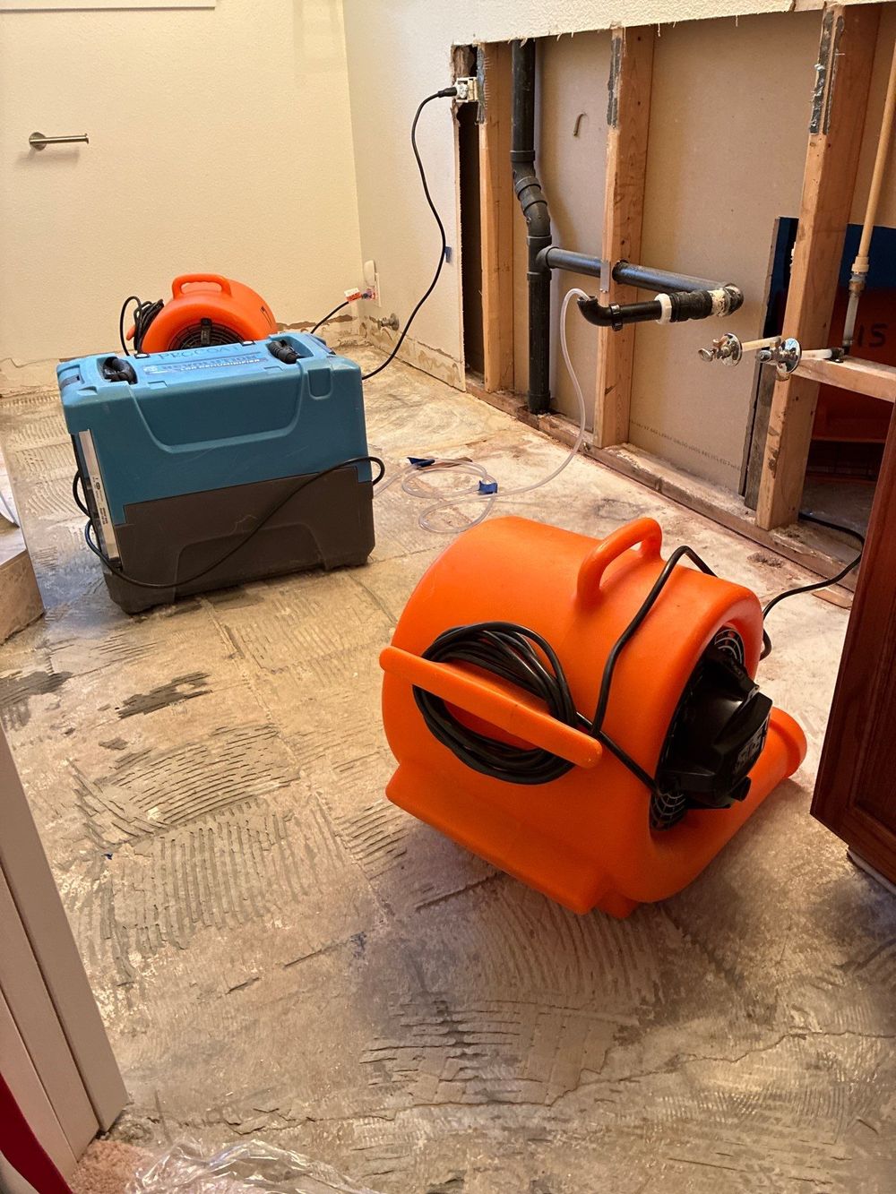 ProCoat air movers and drying equipment in a water-damaged room
